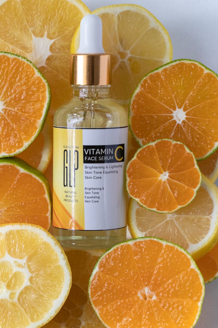 gallery-4 Brightening vitamin C serum surrounded by fresh sliced citrus fruits in a studio setting.